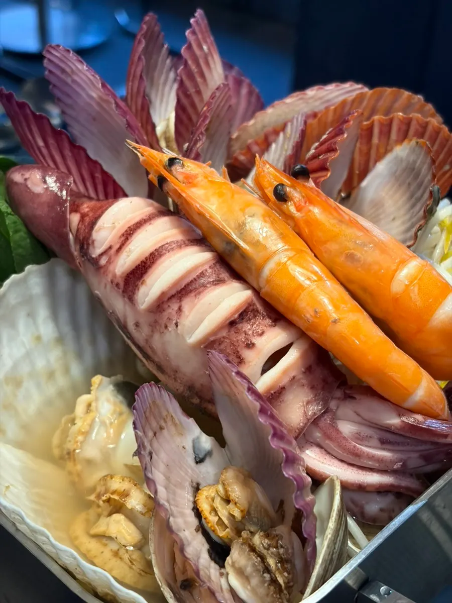 A generous seafood boil with squid, shrimp, and scallops