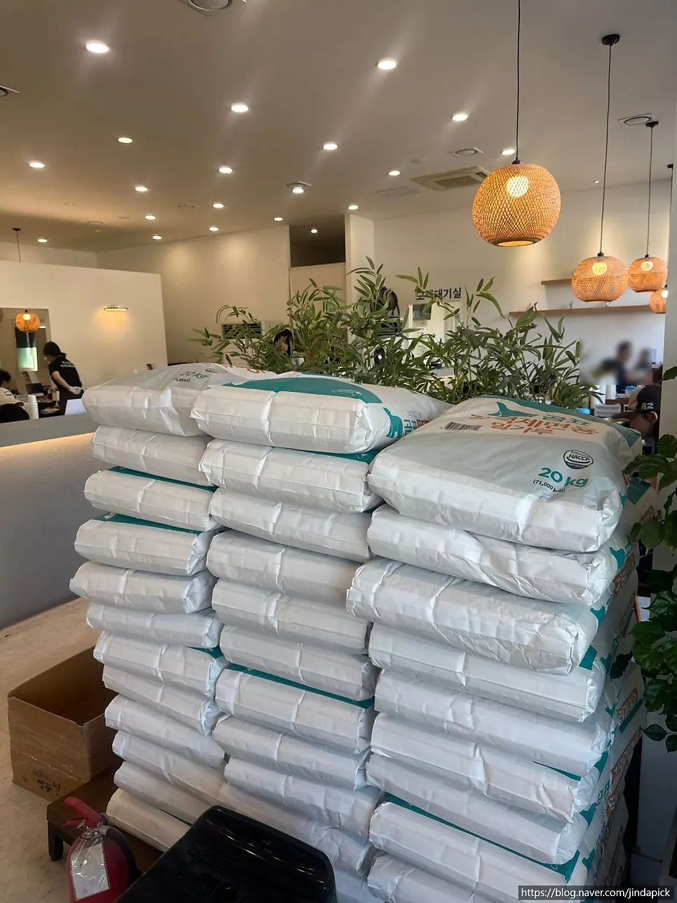 20kg flour sacks stacked on one side of the dining hall