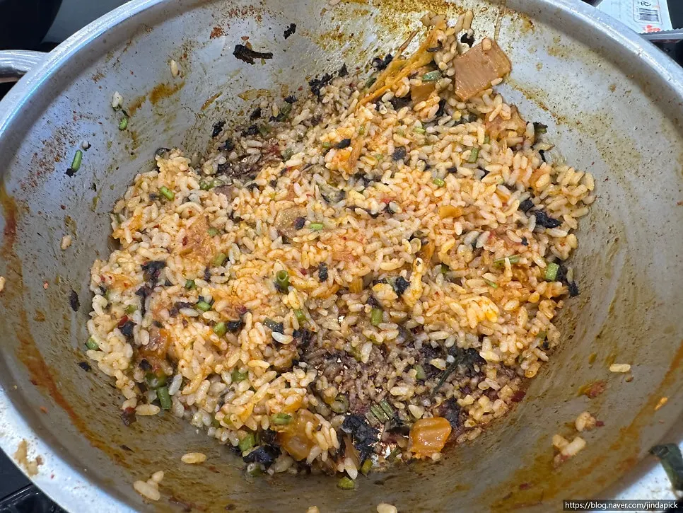 Pot with fried rice ingredients added