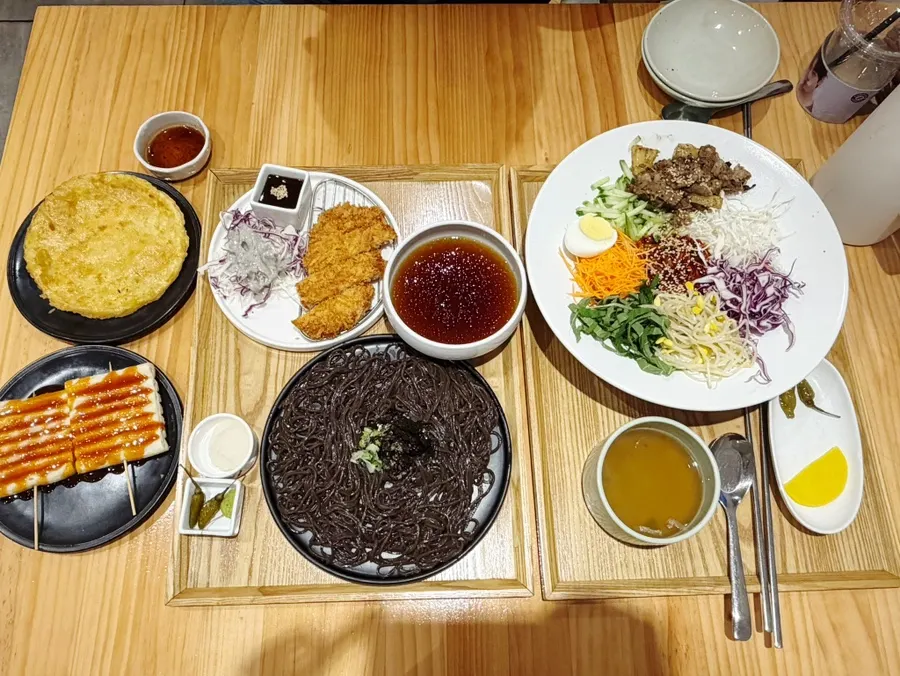 A full table of ordered noodle dishes and sides