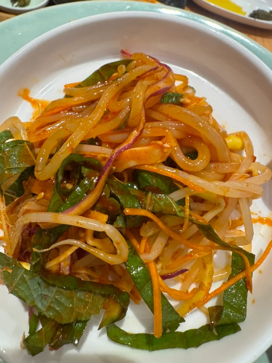 Close-up of Insaeng Jjolmyeon noodles mixed with sauce