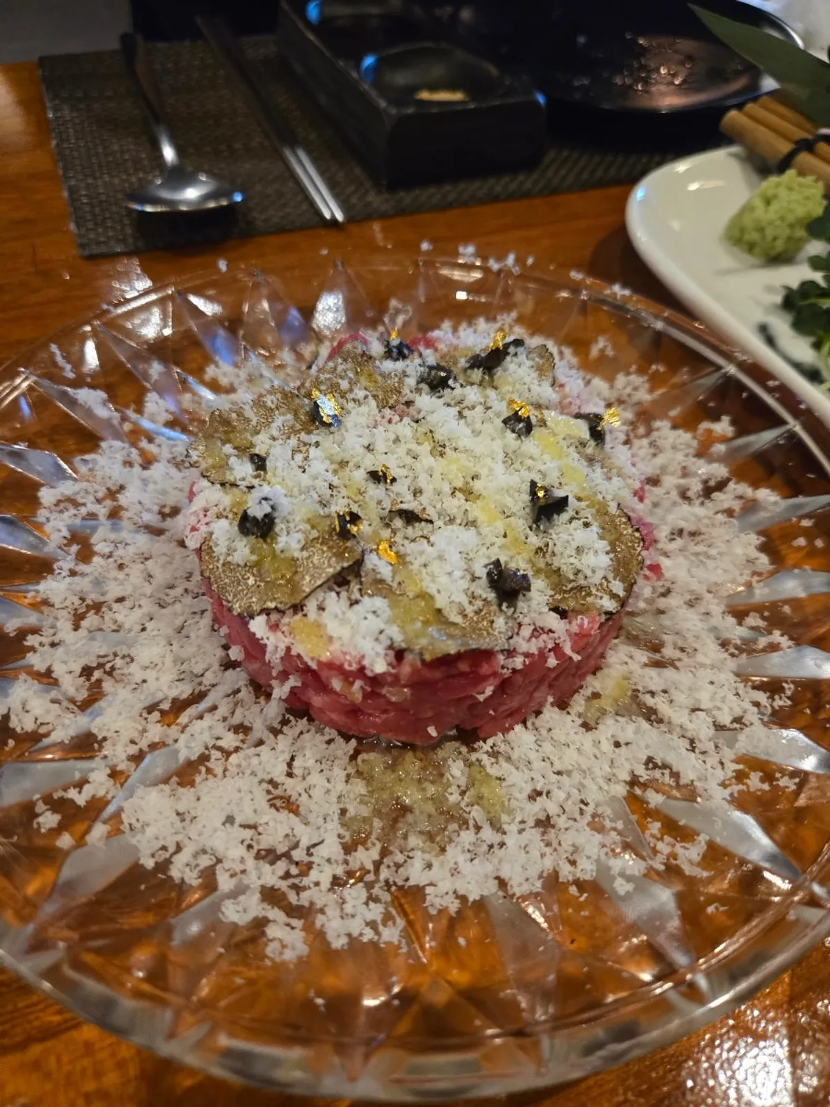 Truffle hanwoo tartare topped with gold flakes and cheese