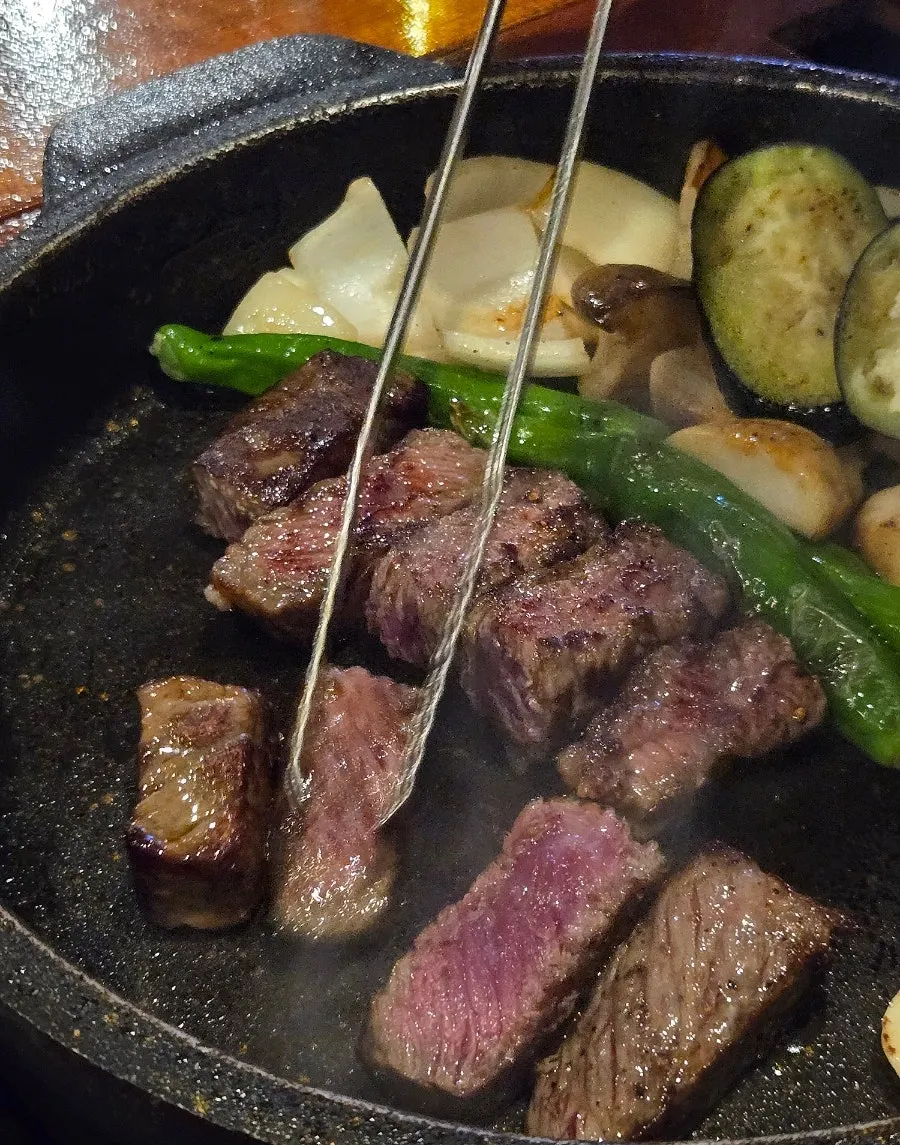 Aged sirloin cooking on the cast-iron pot