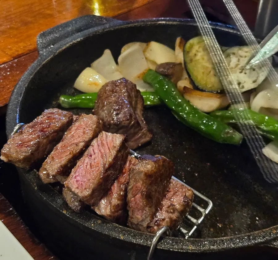 Mushrooms, onion, eggplant and peppers grilling alongside the meat