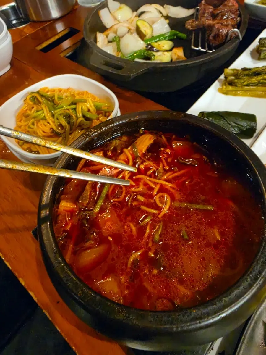 Table setting with grilled meat and haejangmyeon
