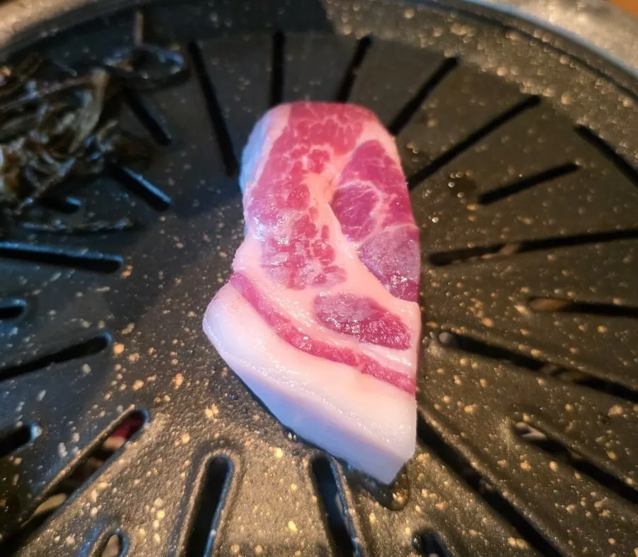 Thick black pork neck dipped in salt