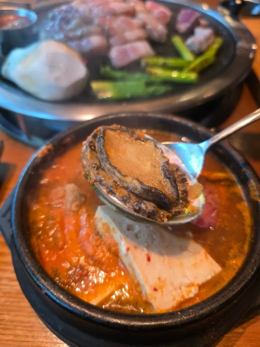 Seafood doenjang jjigae pot with a whole abalone