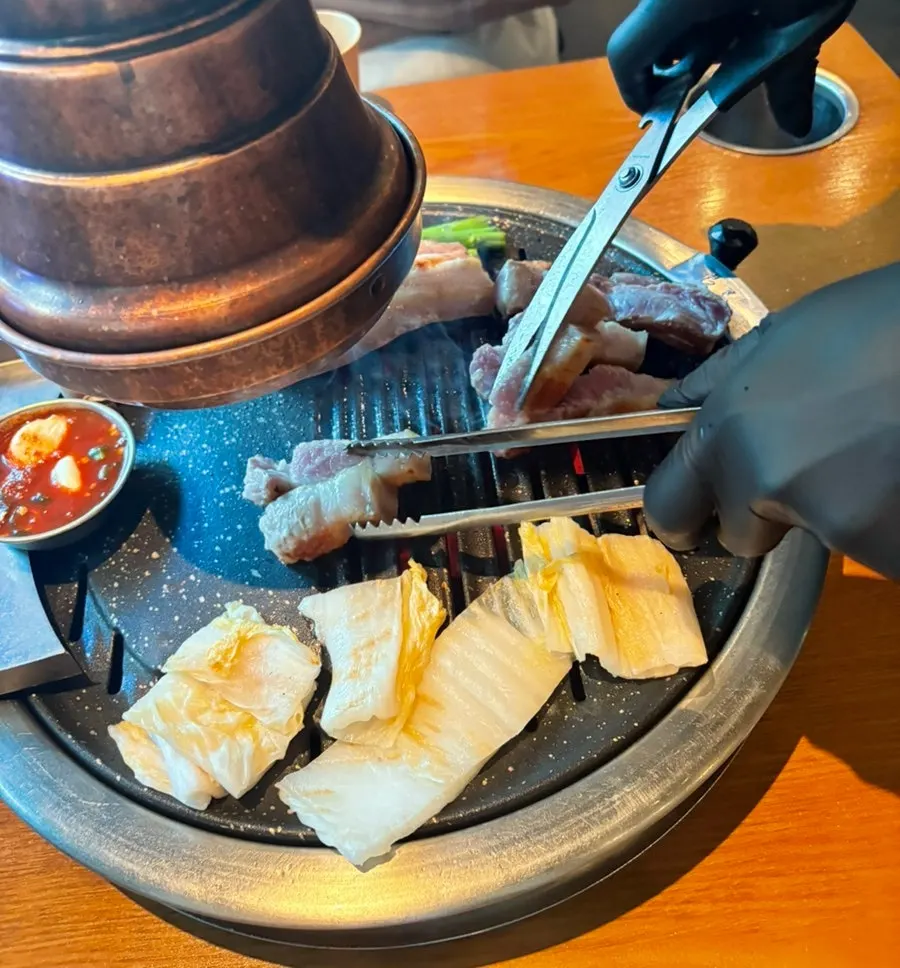 Jeju black pork grilling over the charcoal fire
