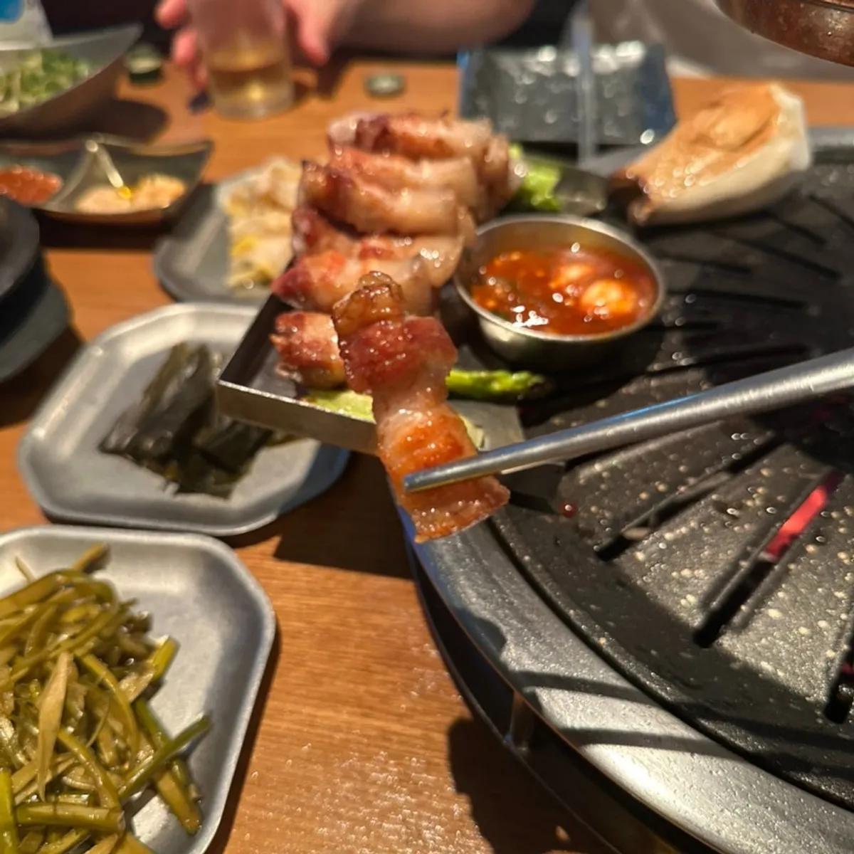 A bite of black pork ogyeopsal dipped in salt