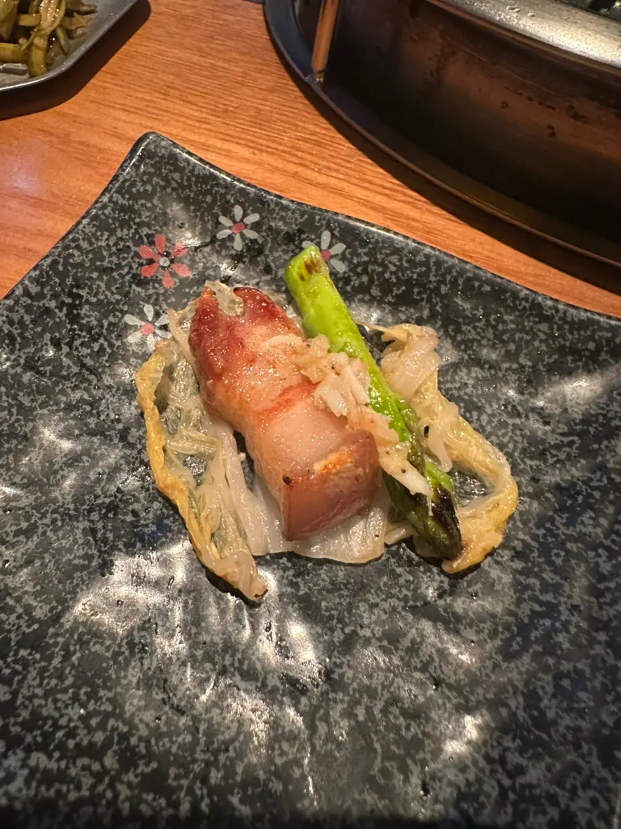 Meat paired with grilled baek-kimchi and asparagus