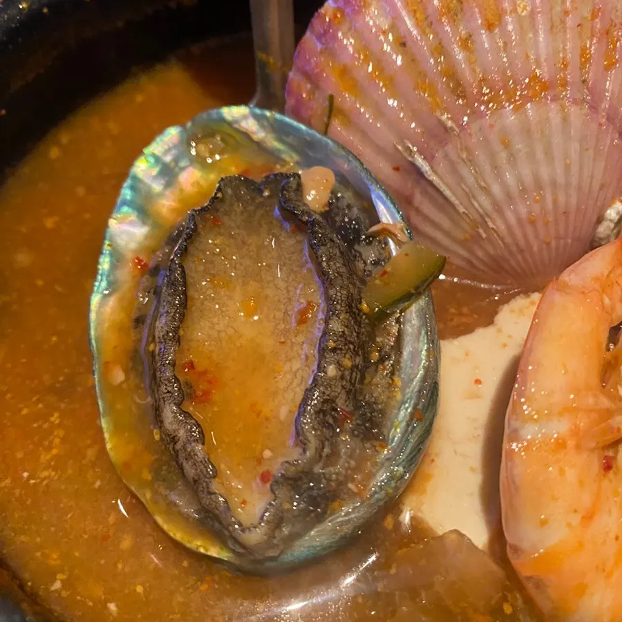 Broth and ingredients of the seafood doenjang jjigae