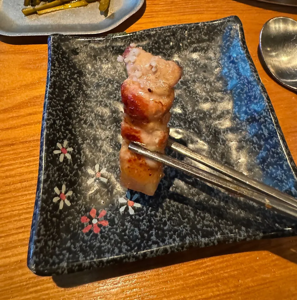 Fully cooked black pork set aside on the grill