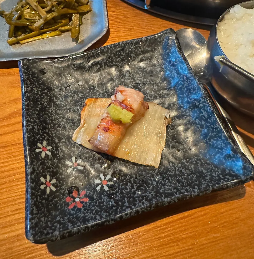A piece of black pork belly dipped in salt