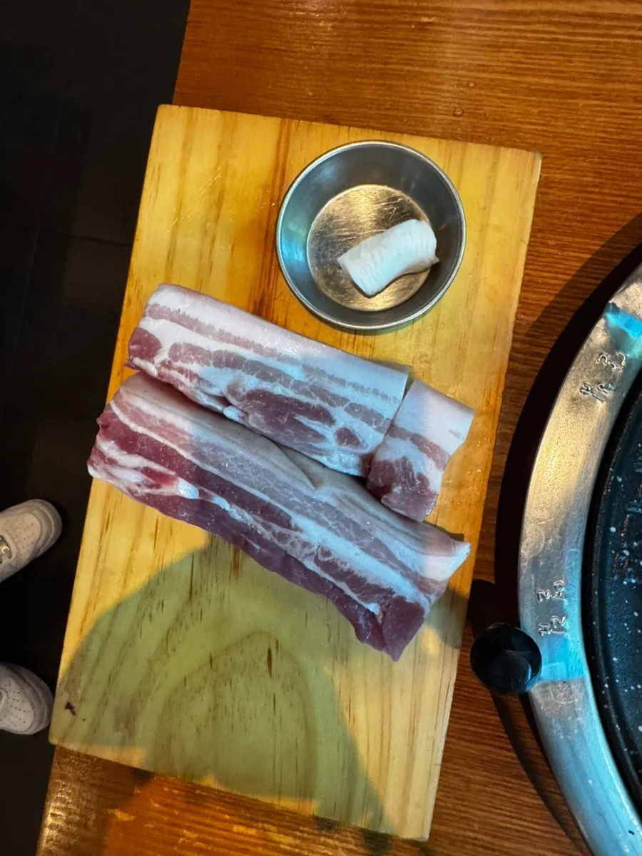 Jeju o-gyeopsal being carefully grilled