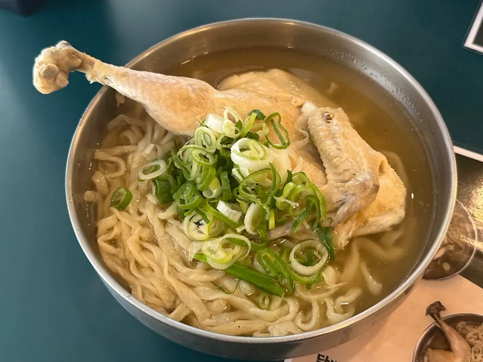 Half-chicken kalguksu topped with a big piece of chicken
