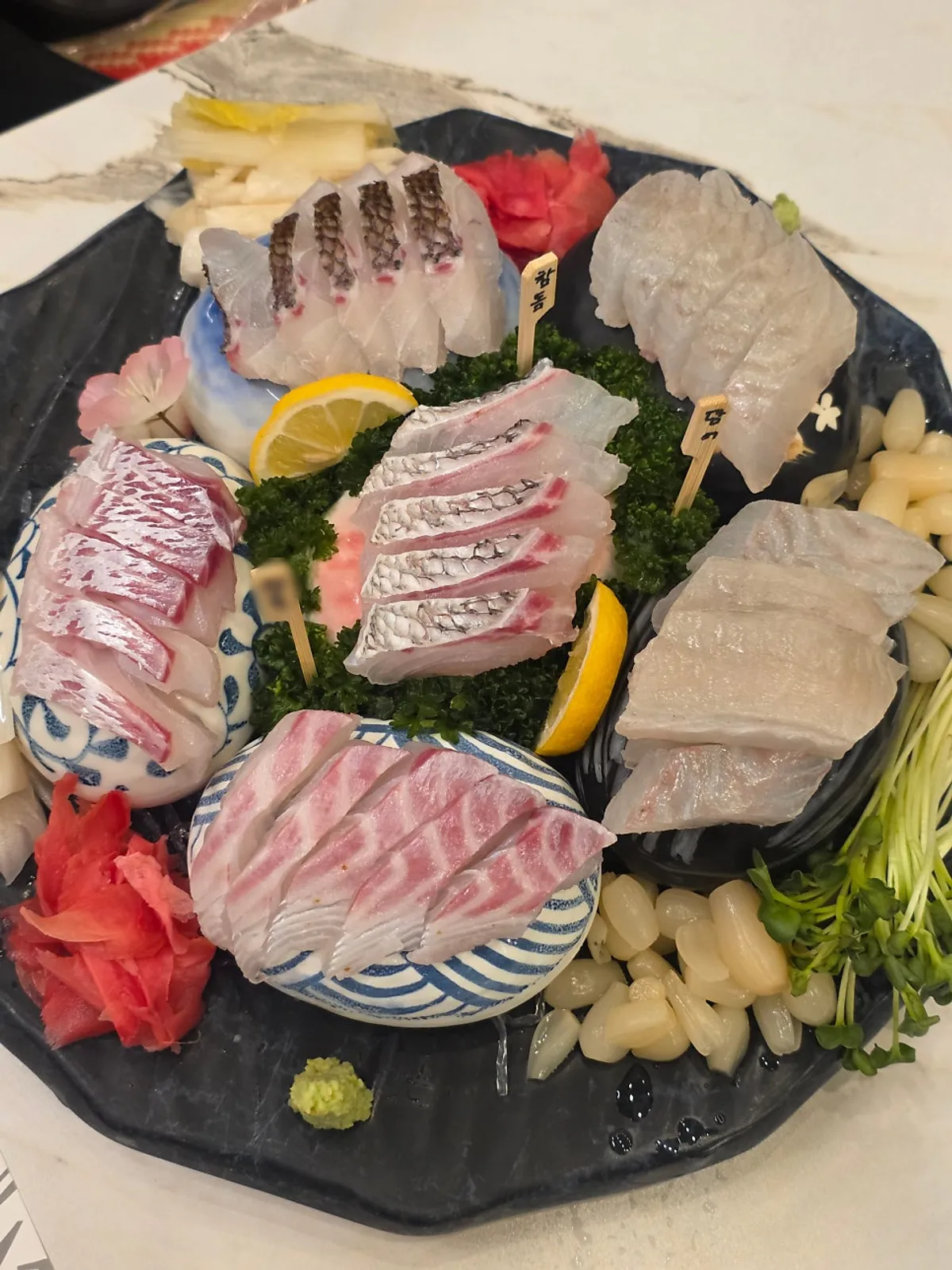 A spread of Haeseon's aged sashimi centered on flounder, red seabream and rockfish