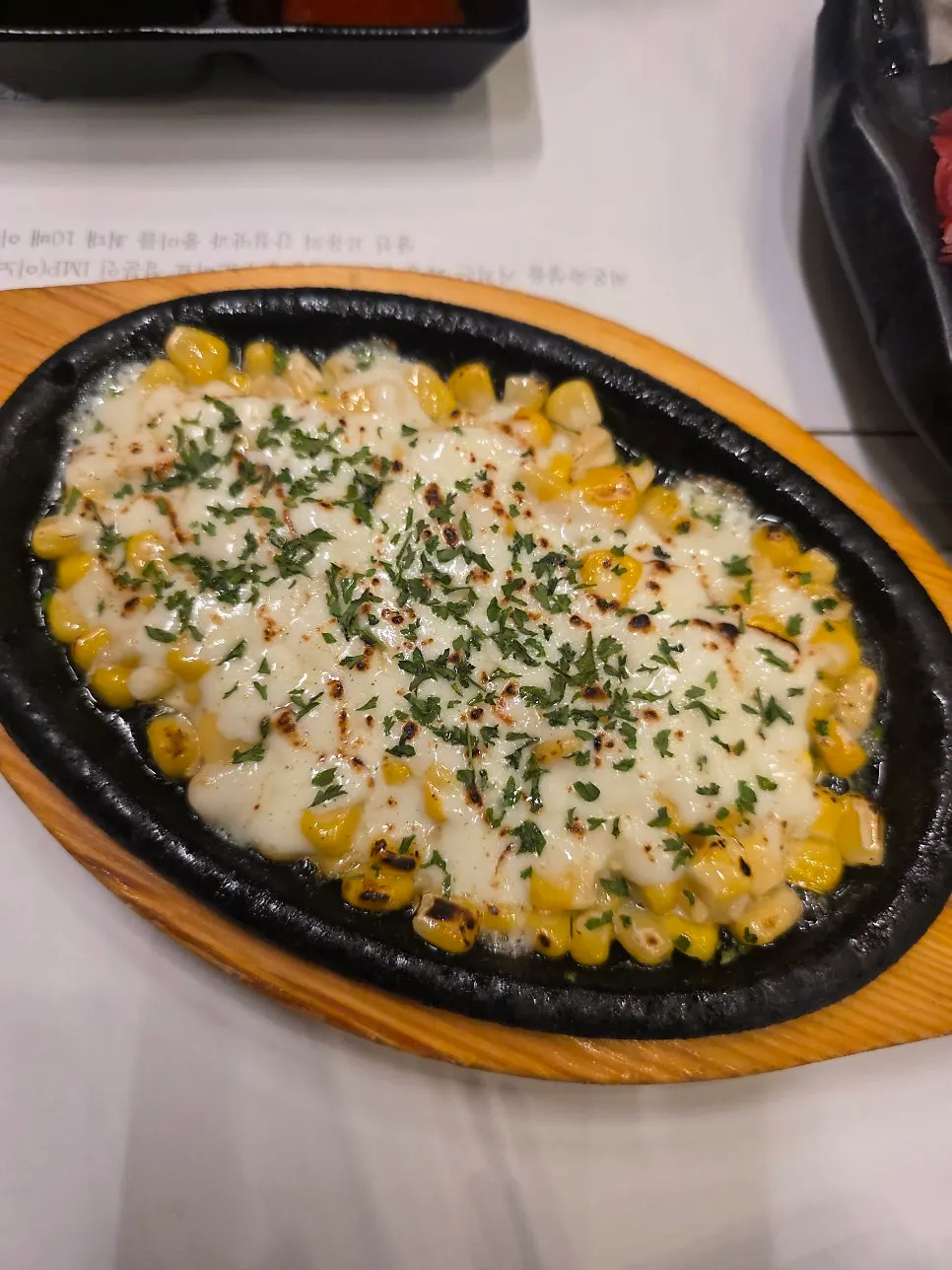 Corn cheese and grilled fish head served mid-course