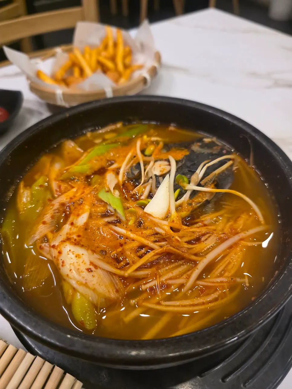 The course's final dish: spicy fish stew in a stone pot