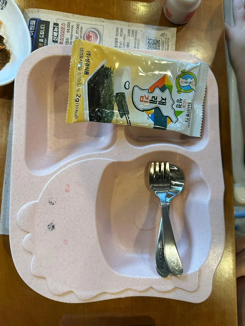 Kids’ tableware and a baby chair prepared for diners