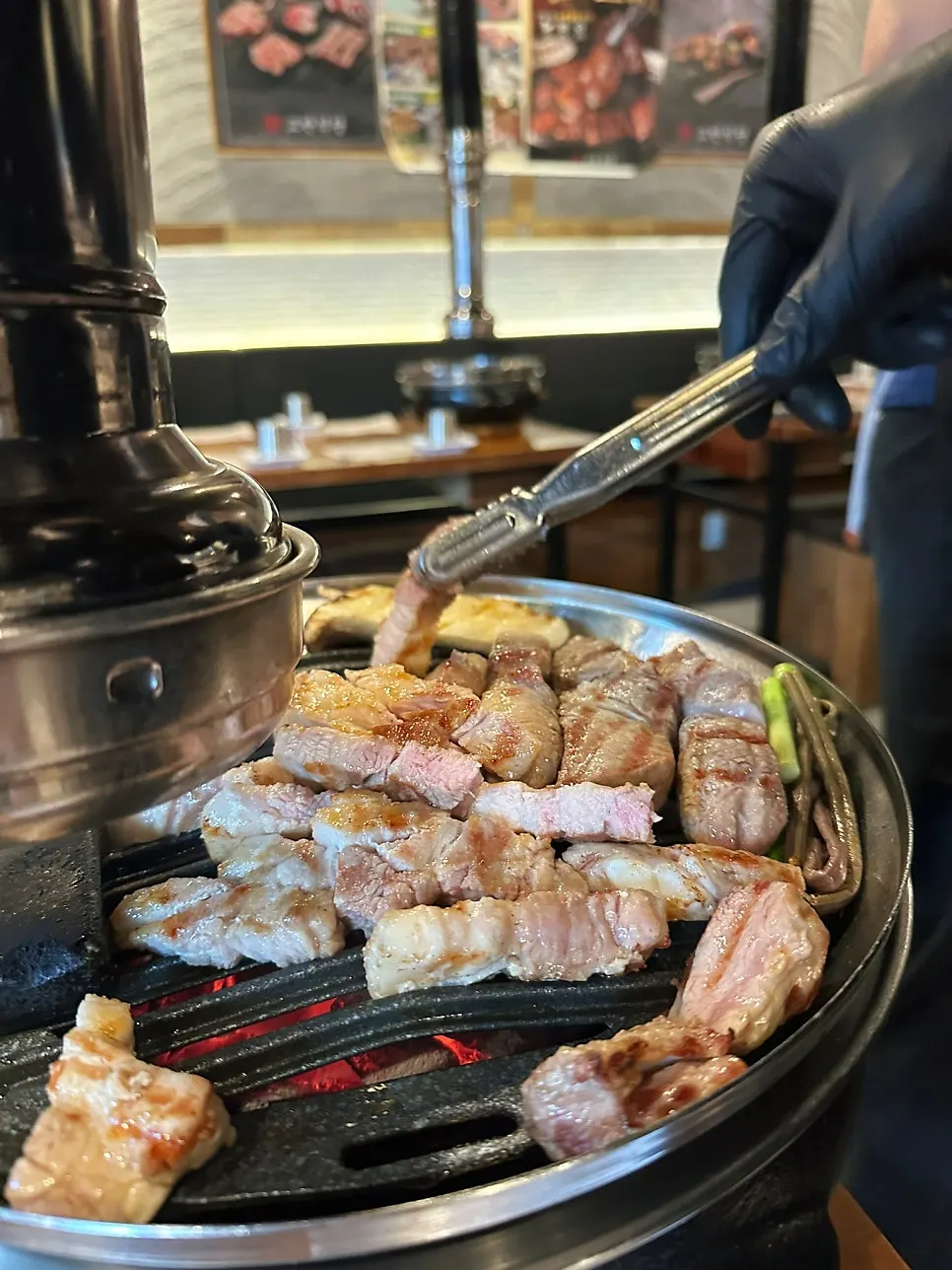 A staff member grilling meat during the meal