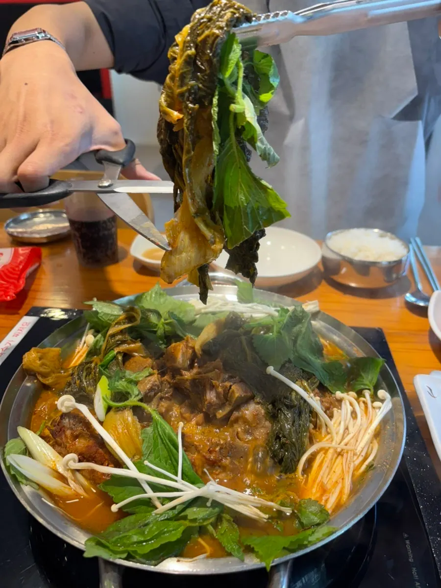 Close-up of bone stew full of napa cabbage and meat