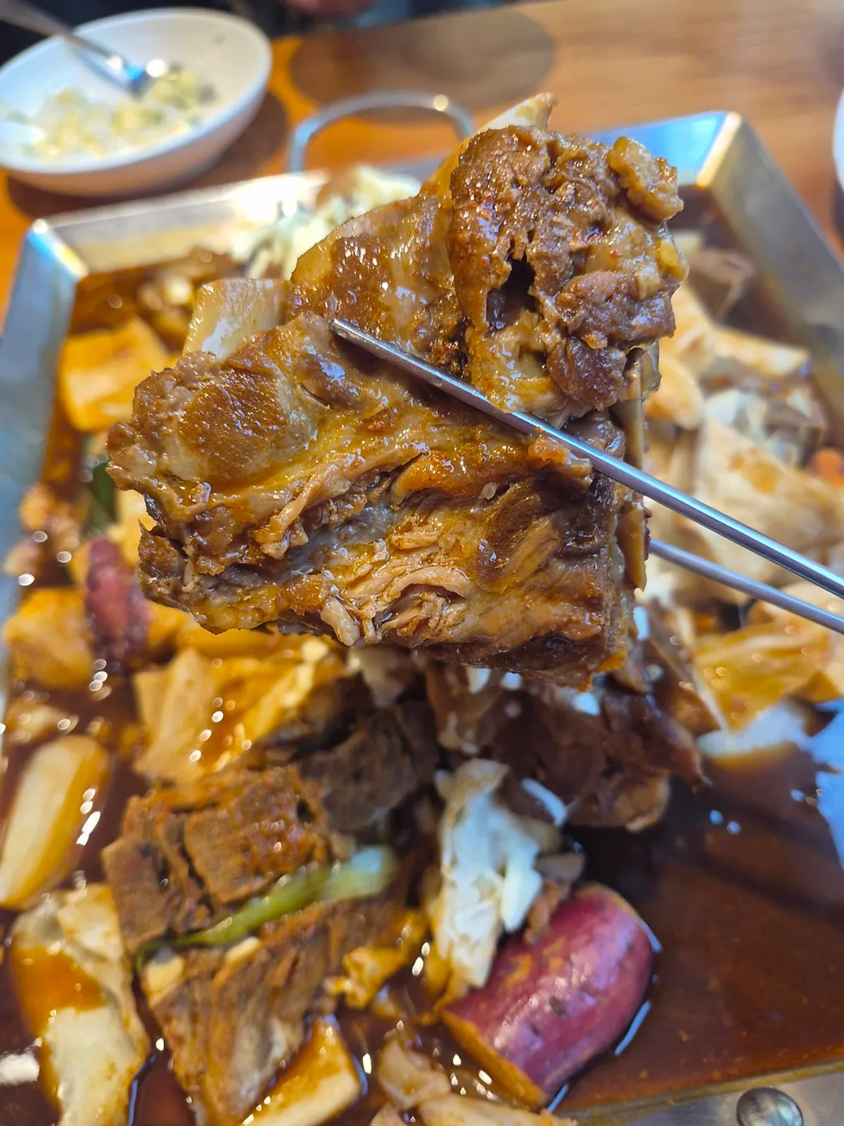 Mild-spice pork bone stew meat covered in melted mozzarella cheese