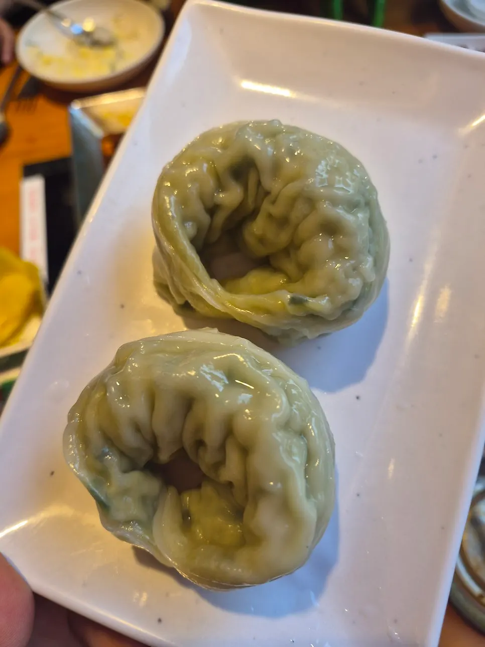 Pork bone stew meat rolled up with cheese and lifted on chopsticks