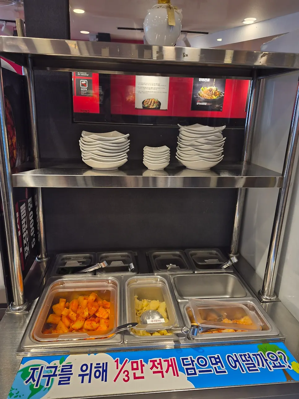 Self-serve side dish bar with diced radish kimchi and kimchi