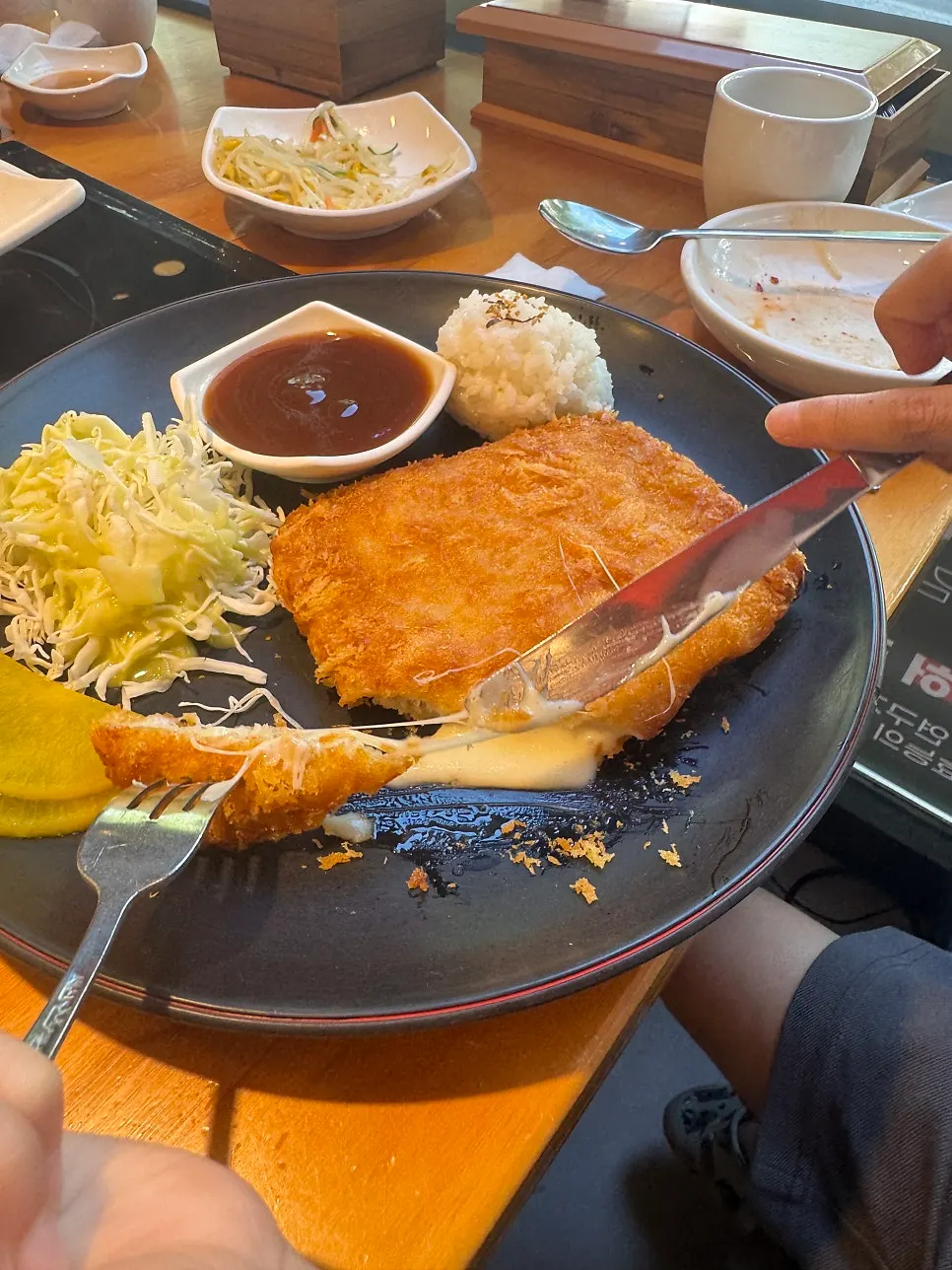 Cheese oozing out as the pork cutlet is cut