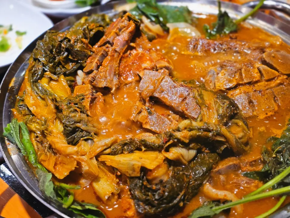 Bone meat and napa cabbage greens scooped into a side bowl
