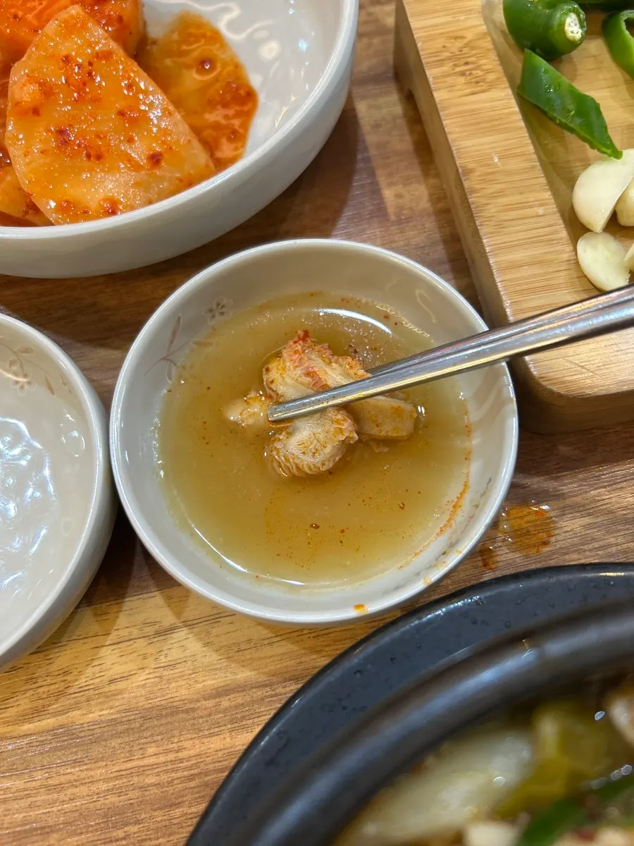 A piece of blood cube dipped in mustard sauce