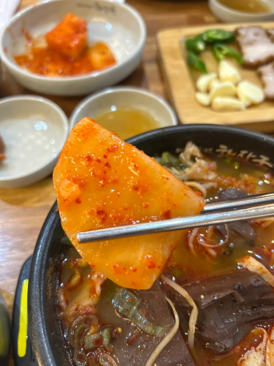 Spoonful of tripe soup mixed with rice