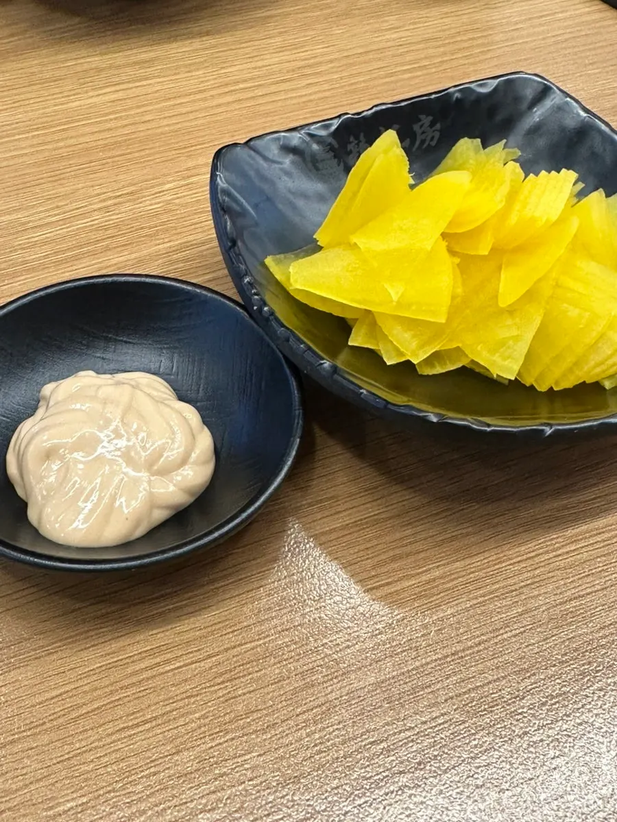 Peanut sauce and pickled radish brought to the table