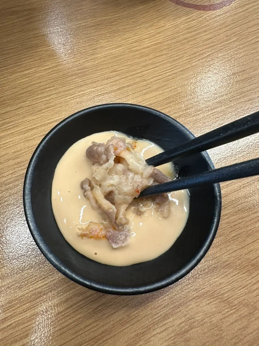 Malatang ingredients dipped in peanut sauce