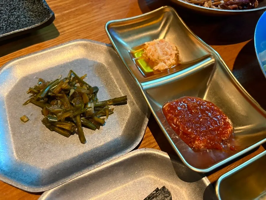Seasoned bracken fern, salted garlic shrimp, ssamjang, and other basic sides