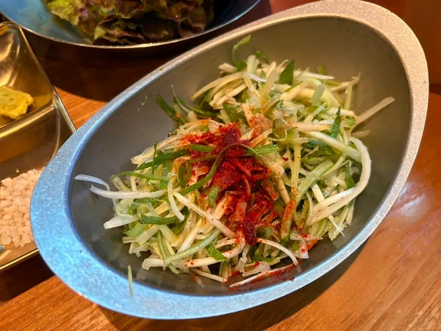 Scallion salad tossed with sesame oil and chili flakes