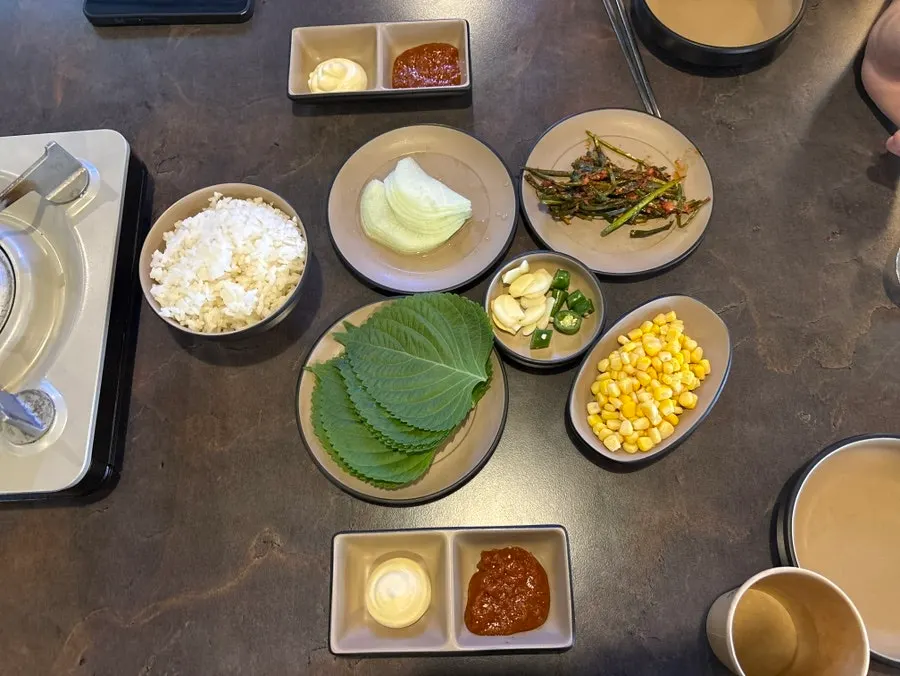 Korean pork belly kimchi grill with side dishes for wraps