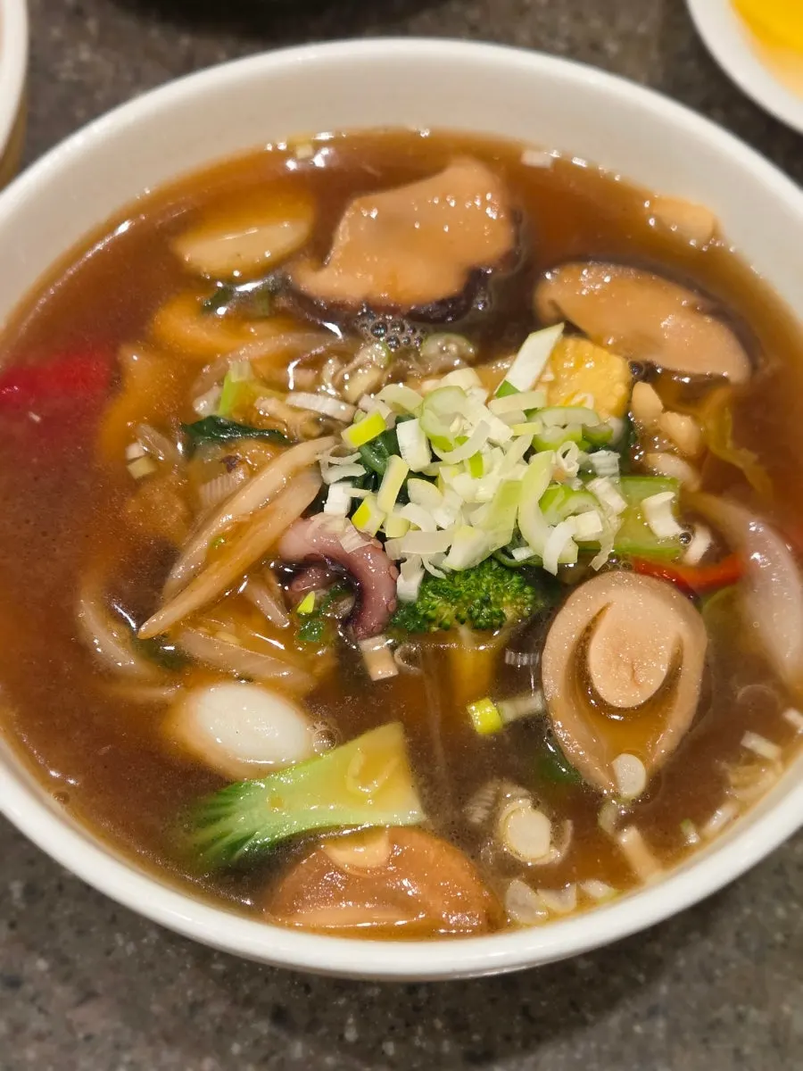 Noodles lifted from a bowl of paljin tangmyeon