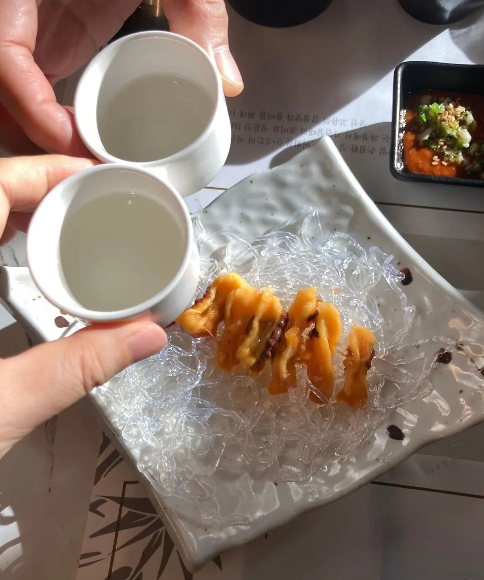 Table setting with sake and sea squirt