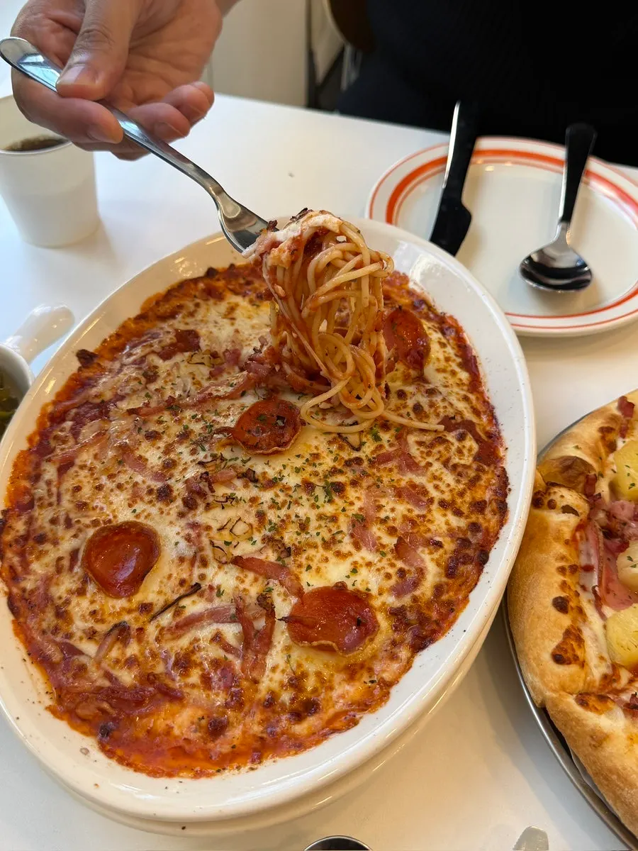 Serving steaming hot oven pasta onto a plate