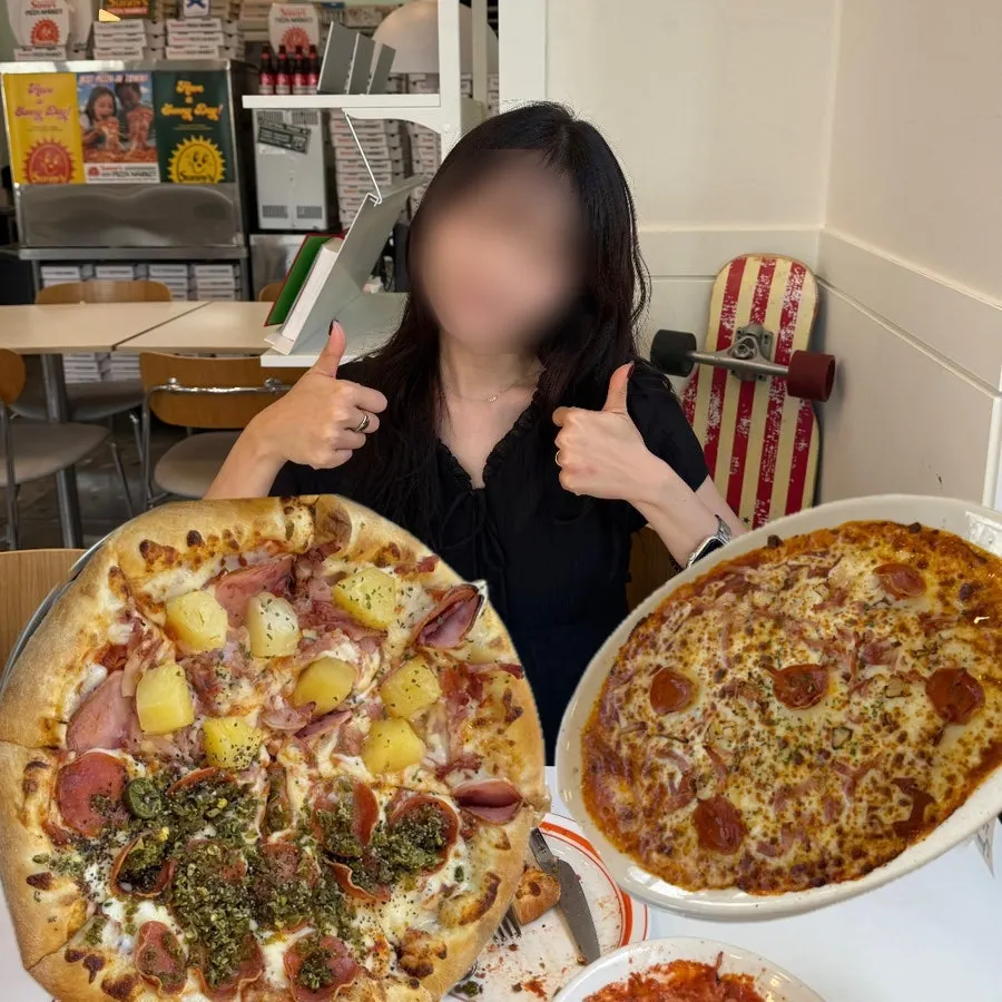 A commemorative photo taken in front of the pizza