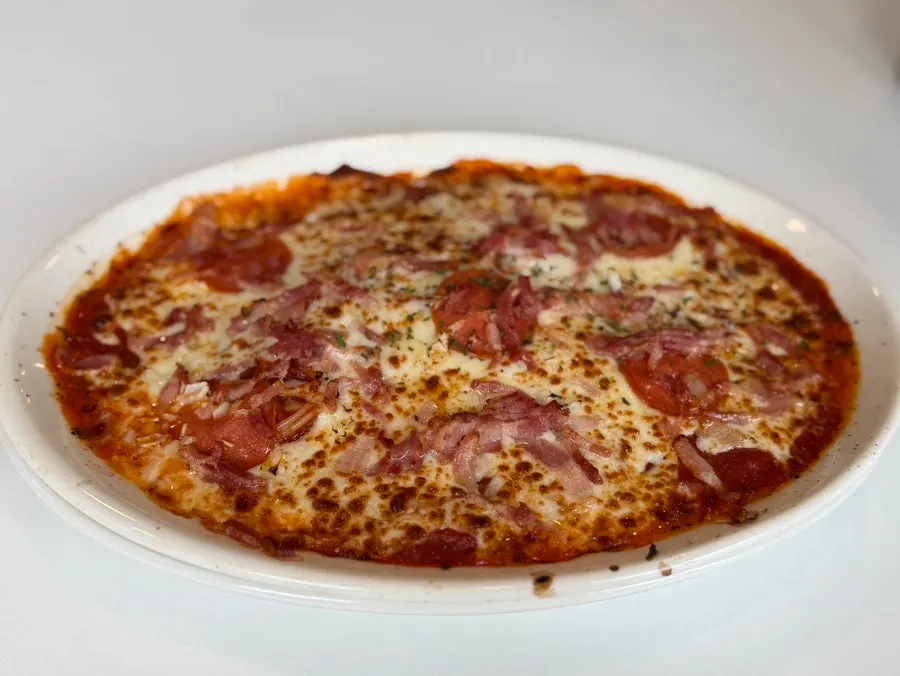 Plate with pickles, parmesan cheese, and sauce