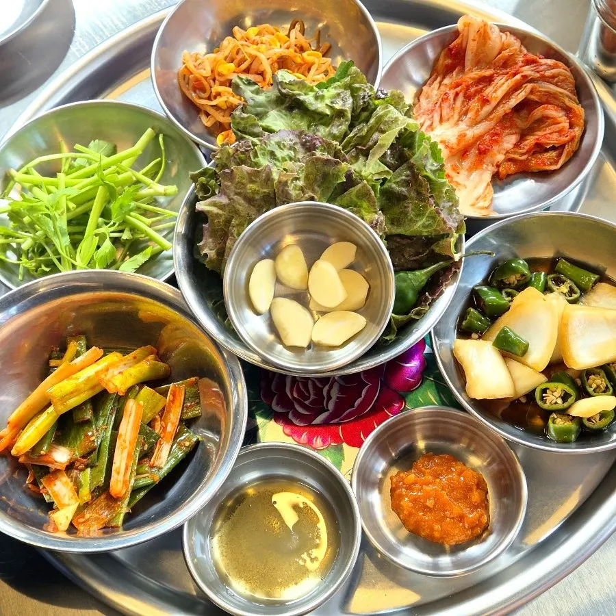 Basic side dish spread including lettuce wraps and scallion salad