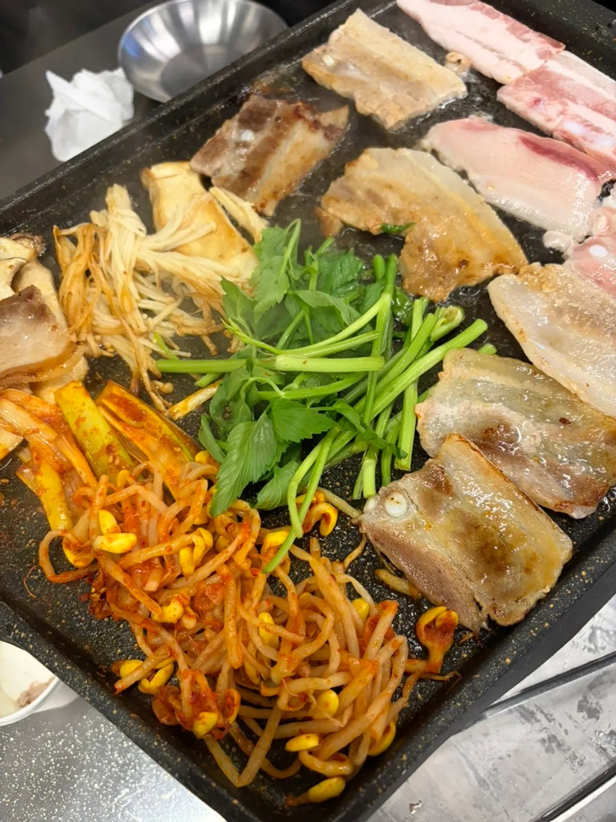 Grill packed with naengsam, scallion kimchi, enoki mushrooms and minari