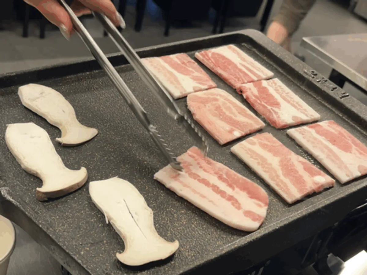 Frozen pork belly on the grill