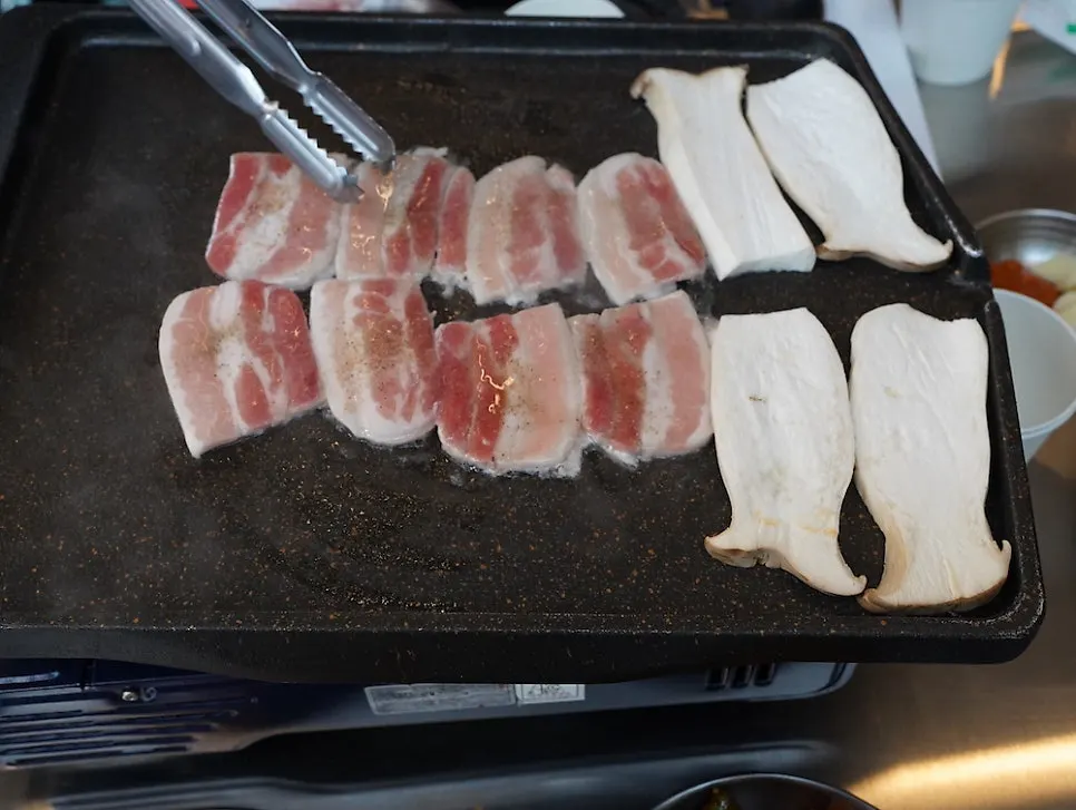 Frozen pork belly grilling on the pan