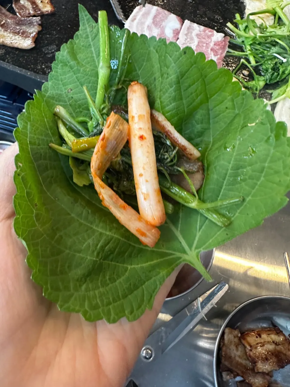 Grilled kimchi and bean sprouts on the pan next to white rice