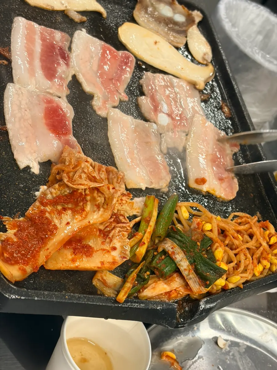 Kimchi and shredded scallion grilling on the pan