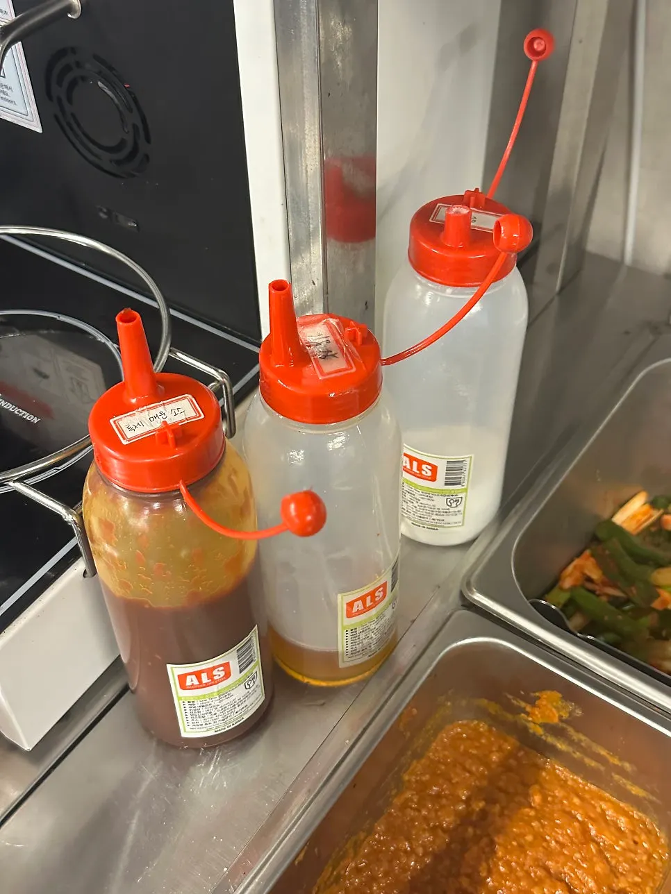 Scallion kimchi and bean sprouts among self-service bar side dishes