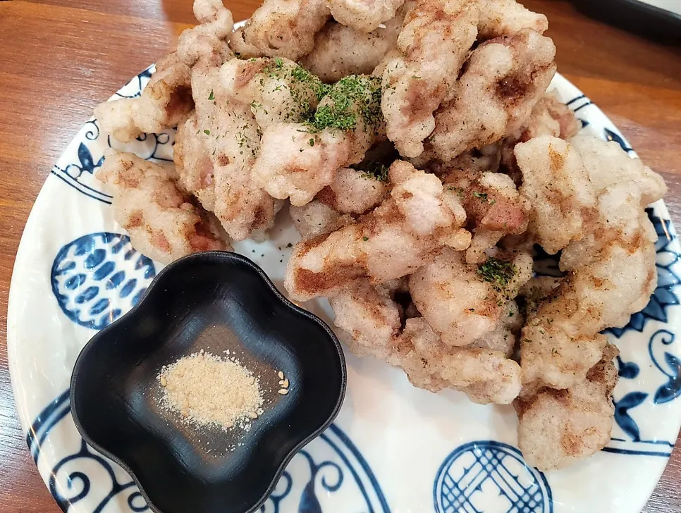 A piece of tangsuyuk dipped in sauce